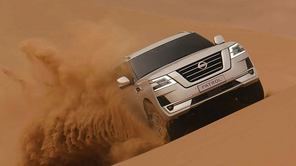 Patrol Nissan SUV dune-bashing in desert